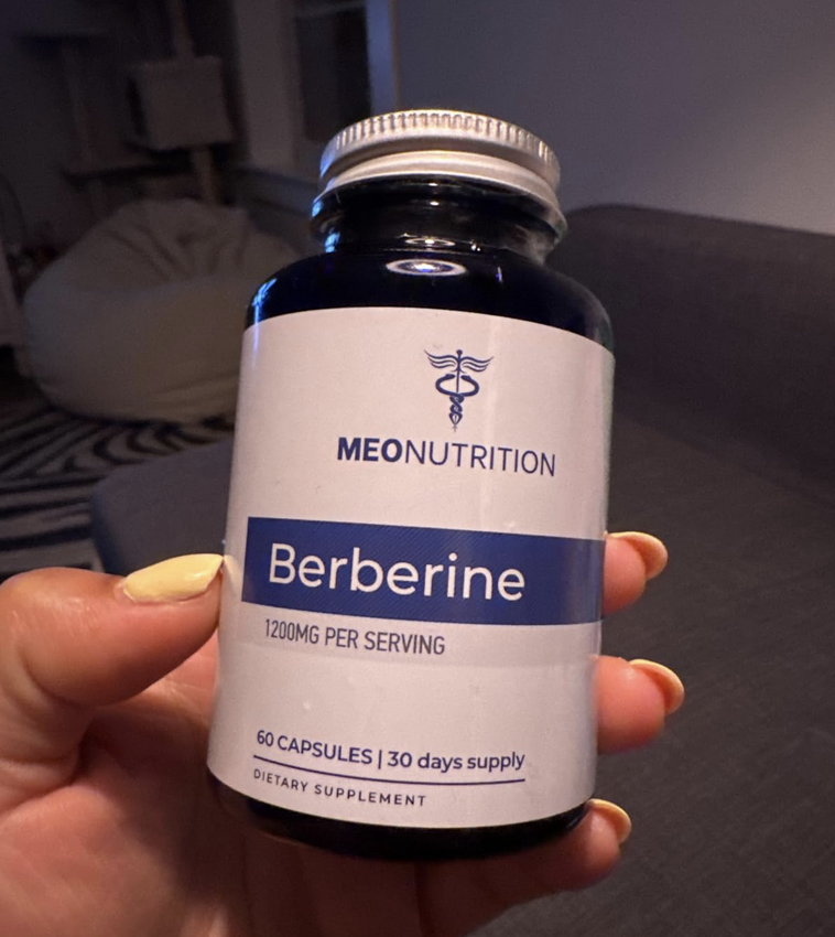 Customer holding Meo Nutrition Berberine supplement bottle